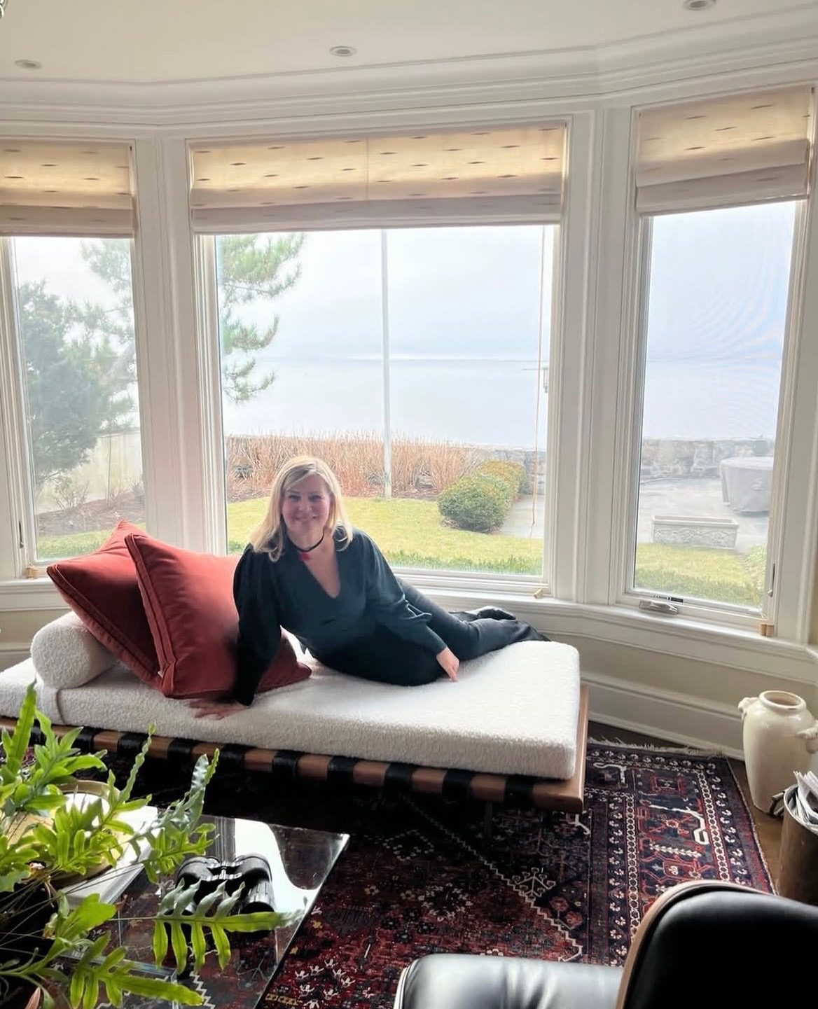 Suzy in a client's finished sunroom overlooking the water