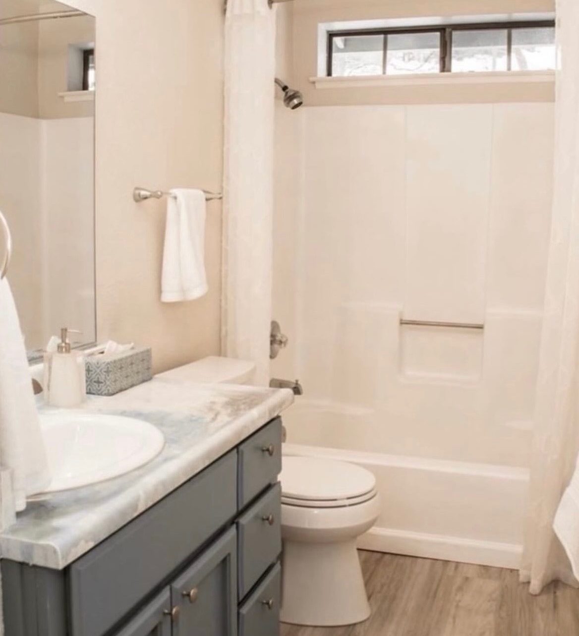 Refreshed bathroom with gray vanity and marble-look countertop