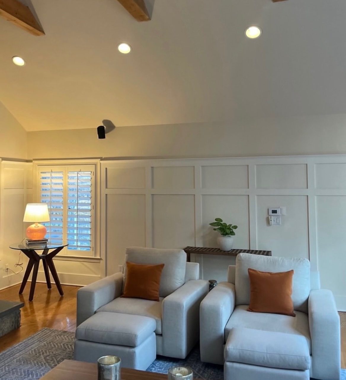 Family room with vaulted wood-beam ceiling and board-and-batten walls